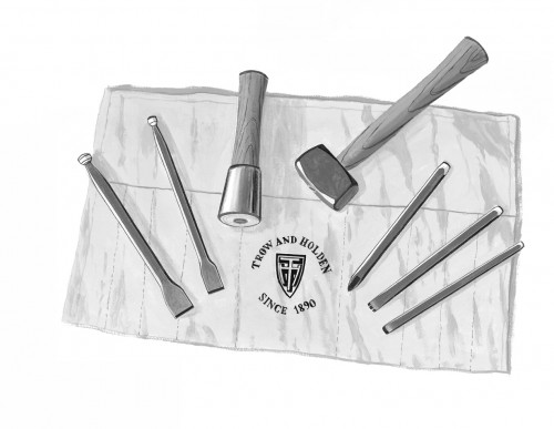 Hard stone hand carving set laid out attractively with hammers chisels and other stone shaping tools