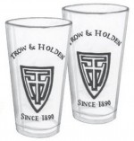 Two tall drinking glasses with the trow and holden logo
