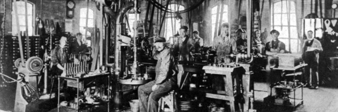 A old black and white picture of workers making masonry tools
