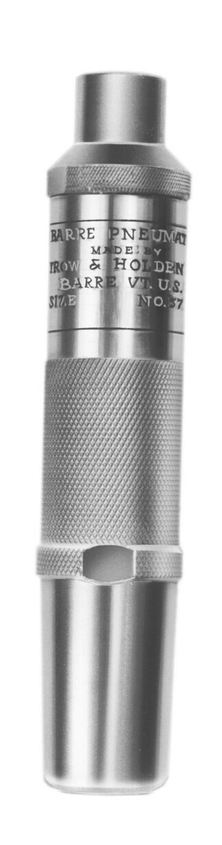 A close up of a type d pneumatic hammer used for stone shaping